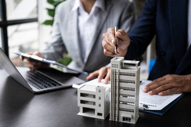 Real-estate agents reviewing a property enquiry