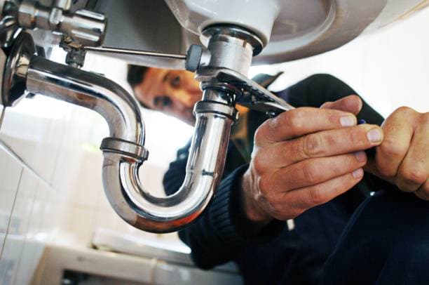 A technician working on a plumbing repair