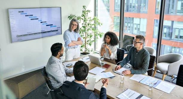 A consultant presenting a project roadmap to a team in a meeting room