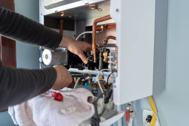 A technician servicing a home heating system