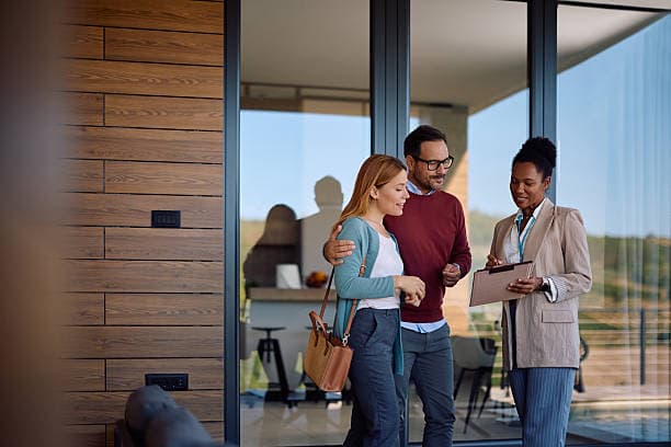 A real-estate agent showing a property to prospective buyers
